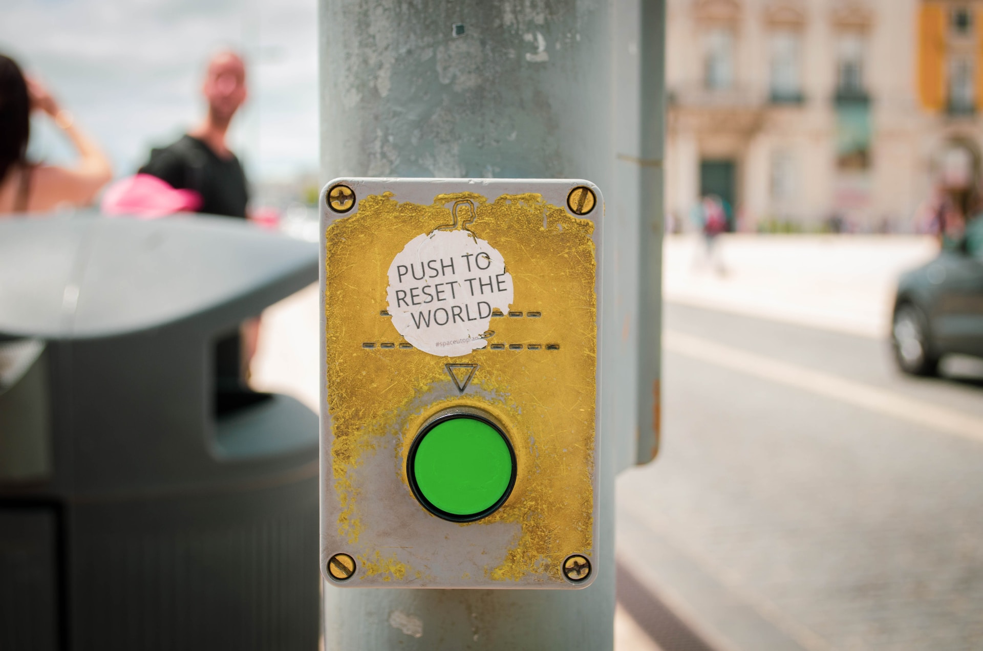 A big green reset button taped to a pole. Courtesy: Unsplash